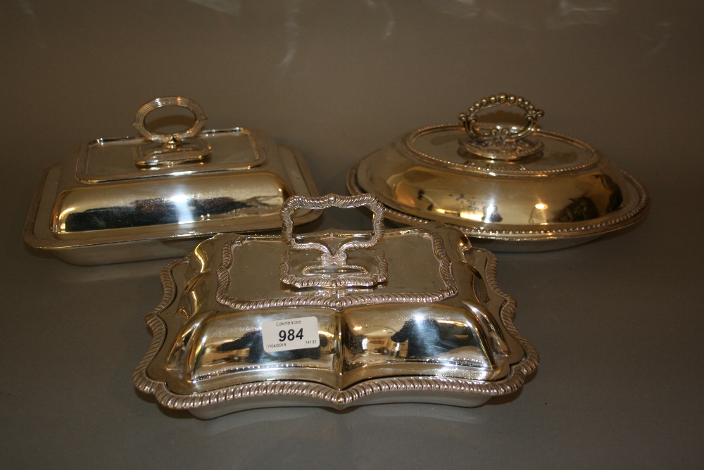 Three various plated entree dishes with covers and handles