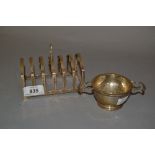 Birmingham silver six division toast rack and a silver tea strainer