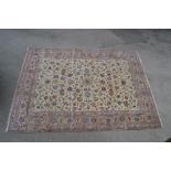 Tabriz carpet having all-over floral design with borders on a beige ground,