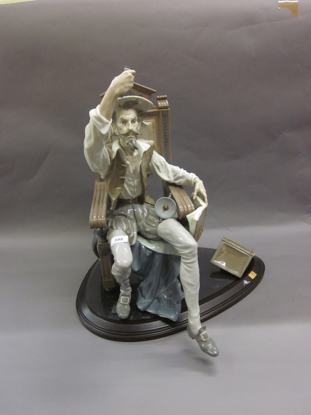 Large Lladro figure of a seated Don Quixote holding sword aloft (at fault - pieces of books