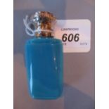 Opaque turquoise glass perfume bottle with ornate white metal top, 7.