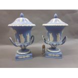 Pair of modern Wedgwood pale blue Jasperware campana vases with covers and handles on plinth bases,