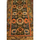 Kurdish rug having central medallion with geometric design and multiple borders on a midnight blue