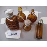 Three various amber glass and white metal mounted perfume bottles,