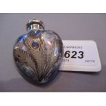 Heart shaped porcelain perfume bottle with decoration in the form of an enamelled peacock feather,