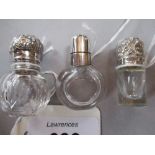 Three miniature clear glass perfume bottles with white metal and silver mounts, 3.