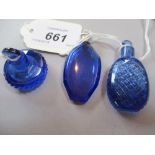 Blue glass ovoid and facet cut scent bottle with a white metal screw top with loop, 5cms high,