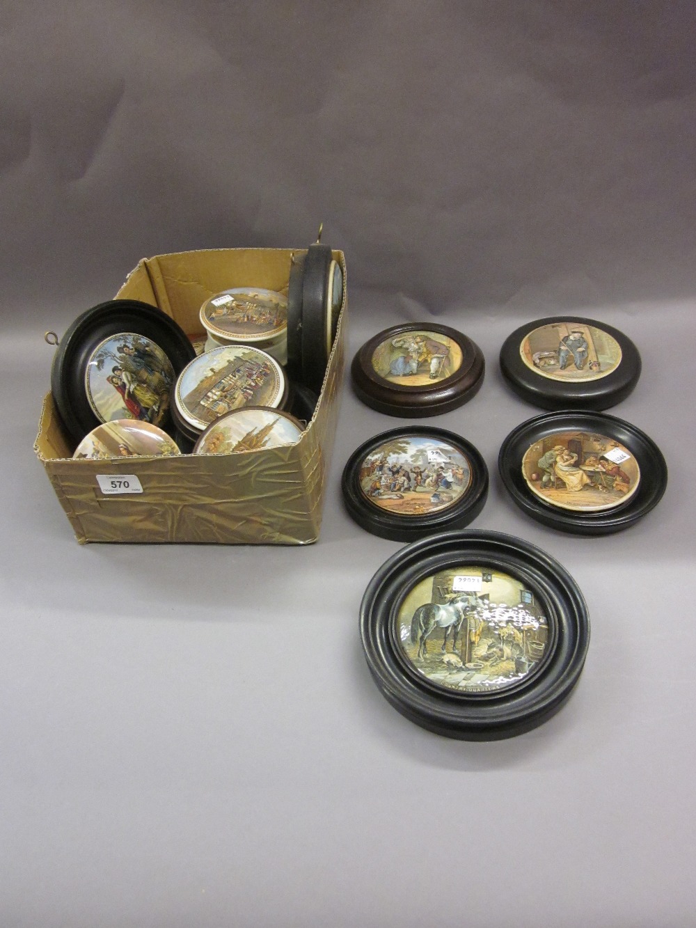 Quantity of various framed pot lids together with a pot lid and base