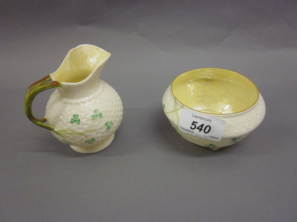 Belleek cream jug with matching sugar bowl having clover leaf decoration and green stamp