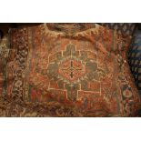 Kurdish rug with trefoil medallion and multiple borders on a wine ground,