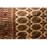 Beige ground Bokhara pattern machine rug, 1.9m x 1.