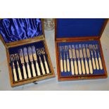 Mahogany cased set of twelve silver plated dessert knives and forks and an oak cased set of eight