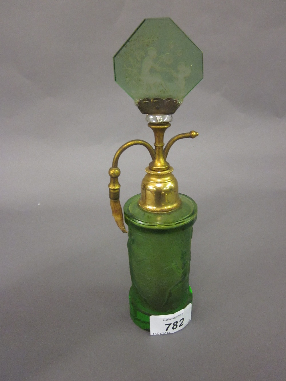 Art Deco green glass and gilt metal perfume atomiser relief moulded with figures