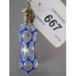 Blue and white double overlay waisted perfume bottle with ornate white metal lid and attached chain