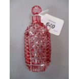 Ornate red overlay and cut glass perfume bottle with matching red cut stopper,
