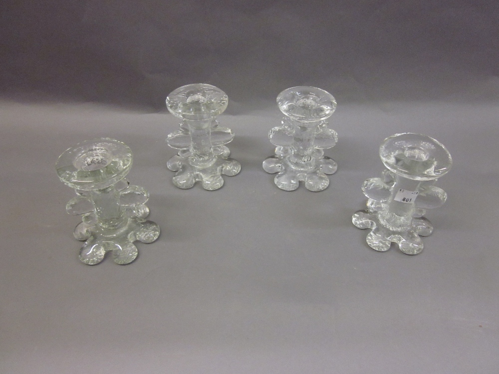 Four Pukeberg glass single stem candlesticks designed by Staffan Gellerstedt