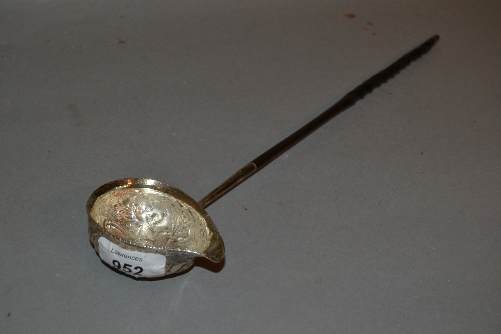 Antique white metal toddy ladle inset with a George II coin with a twisted whale bone handle