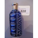 Blue overlay cut glass perfume bottle with plain push-on white metal top and stopper,