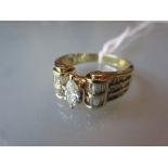 14ct Yellow gold ring with scroll shoulders set central marquise cut diamond and baguette cut