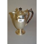 Birmingham silver circular pedestal hot water pot with ebonised handles and finial