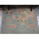Chinese dragon decorated rug on a pale blue ground