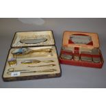 Cased gold plated and hand painted enamel ladies dressing table set together with another cased