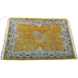 Chinese carpet with embossed dragon design on a yellow ground,