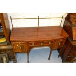 Small George III mahogany and satinwood crossbanded bow fronted sideboard with a brass rail back