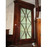 George III mahogany and oak hanging corner cabinet with a glazed panel door