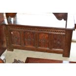 17th Century oak coffer with a moulded plank lid above a carved frieze and four panel front on