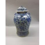 Chinese porcelain baluster form temple jar with cover with blue and white all-over floral