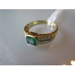 Yellow gold emerald set ring with diamond set shoulders (at fault)