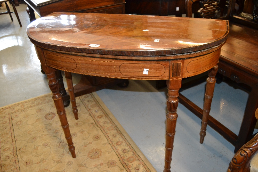 George III figured mahogany satinwood crossbanded and line inlaid D-shaped fold-over card table,