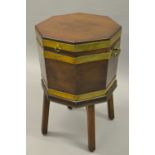 George III mahogany and brass bound octagonal wine cooler with a hinged moulded lid,