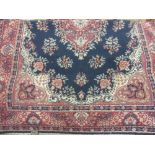 20th Century Persian style rug having central medallion on a blue and red ground with borders, 3.