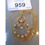 15ct Gold bow pendant set cultured pearls suspended from an 18ct gold chain