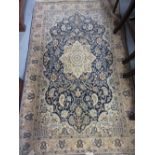 Small Indo Persian rug with medallion and all-over floral design on a blue ground with borders