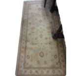 Modern machine woven rug having all-over floral design with borders on a cream ground