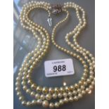 Twin row graduated cultured pearl necklace together with a simulated pearl necklace