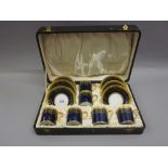 Cased set of six Limoges for Harrods coffee cups with saucers with gilded decoration on a dark blue