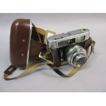 Voigtlander 35mm camera together with a 19th or early 20th Century brass instrument with adjustable