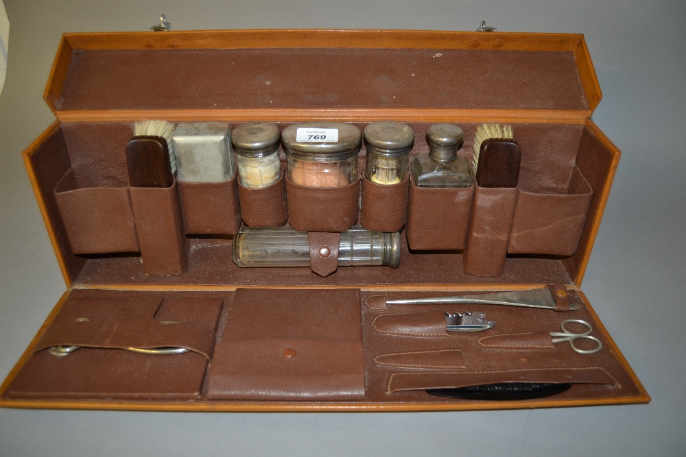 Gentleman's leather cased travelling dressing set with silver mounted glass bottles (some losses),