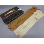 Victorian leather glove case containing various silk and leather gloves, button hook,