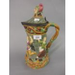 Minton Majolica Carnival Jester jug, the body moulded with figures around a castle wall,