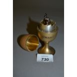 Unusual silver gilt and enamel musical box in the form of an egg in an eggcup,