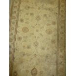 Modern machine woven rug having all-over floral design with borders on a cream ground