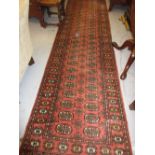 Indo Persian runner of Bokhara design with a twin row of gols on a pink ground