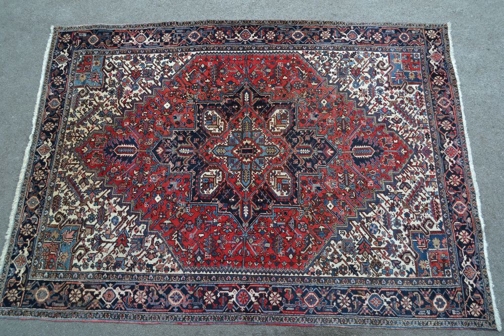 Heriz carpet with a typical lobed medallion and all-over stylised floral design,