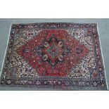 Heriz carpet with a typical lobed medallion and all-over stylised floral design,
