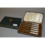 Cased set of six mother of pearl handled tea knives,